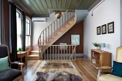 a living room with a staircase and a couch at Tastefully decorated house in Old city - Rose in Istanbul