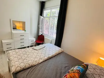 a bedroom with a bed and a dresser and a window at Jasmin in Istanbul