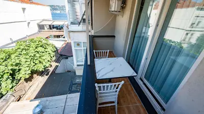a balcony with a table and chairs and a window at Sea Sparkle in Istanbul