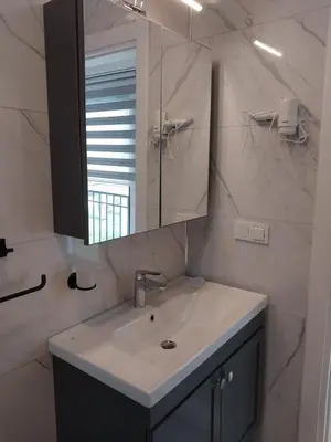 a white bathroom with a sink and a mirror at Orkide Sapanca in Sapanca