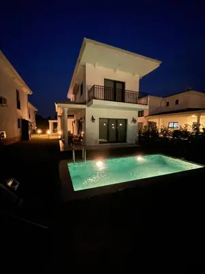 a swimming pool in front of a house at night at Orkide Sapanca in Sapanca