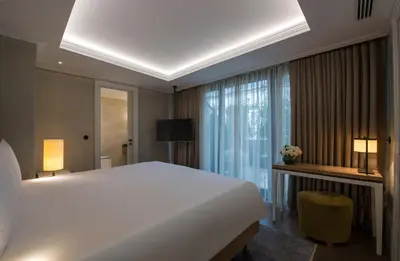 a bedroom with a large white bed and a window at 10 Karakoy in Istanbul