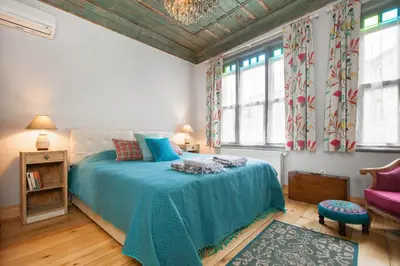 a bedroom with a bed with a blue blanket at Turquoise House Featured in Elle Decor Magazine in Istanbul