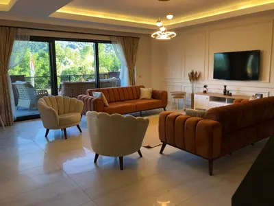 a living room with couches and chairs and a tv at GateMaşukiye in Kartepe