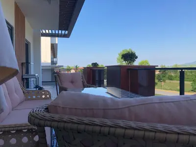 a patio with couches and a table and a fireplace at GateMaşukiye in Kartepe