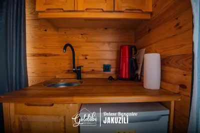 a kitchen counter with a sink in a tiny house at Sapanca Göldibi Suit Bungalov in Sakarya