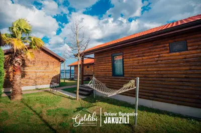 a log cabin with a bench in front of it at Sapanca Göldibi Suit Bungalov in Sakarya