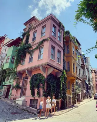 a group of women walking in front of a pink building at Golden Horn Views from The Saffron House in Old Istanbul in Istanbul