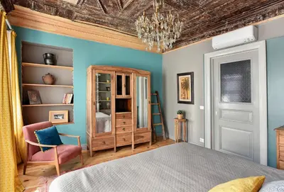 a bedroom with blue walls and a bed and a chair at Golden Horn Views from The Saffron House in Old Istanbul in Istanbul