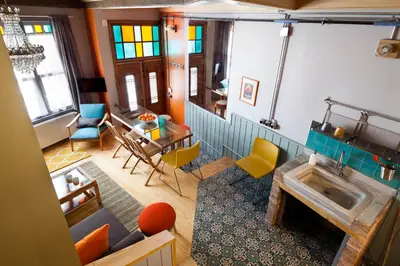 a view of a living room with a table and chairs at Enjoy Golden Horn views from Tangerine house in Istanbul