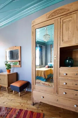 a bedroom with a large wooden cabinet with a mirror at Enjoy Golden Horn views from Tangerine house in Istanbul