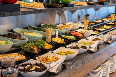 a buffet line with many different types of food at Lilium Hotel & Suites in Bursa