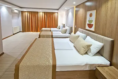 a row of beds in a hotel room at Lion City Hotel in Buyukcekmece