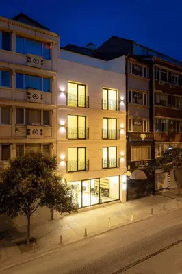 an apartment building at night with its lights on at Great Fortune Concept Hotel in Istanbul
