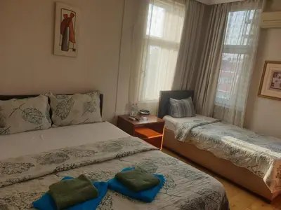 a bedroom with two beds and a window at Hotel Acar in Istanbul