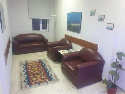 a living room with leather furniture and a rug at Hotel Acar in Istanbul