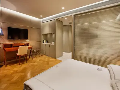 a bedroom with a bed and a desk and a television at Fer Hotel in Istanbul