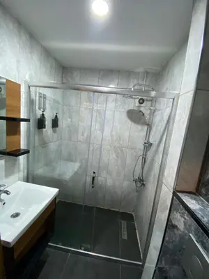a bathroom with a shower and a sink at Green Palmiye Hotel in Avcılar