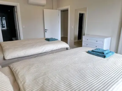 two beds in a bedroom with towels on them at Bamboo Grove 2 and 3 bedroom apartments - Izmit Kocaeli in Çavuşçiftliği