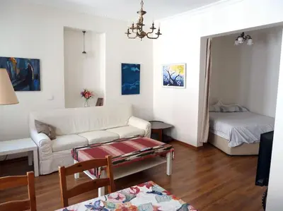 a living room with a couch and a bed at Super Location Cosy Apartment TaximHome 3 at Taksim Cihangir in Istanbul
