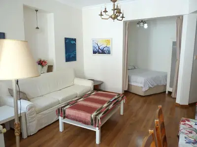 a living room with a white couch and a bed at Super Location Cosy Apartment TaximHome 3 at Taksim Cihangir in Istanbul