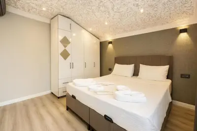 a bedroom with a large bed with towels on it at Casa Florya Suites in Istanbul