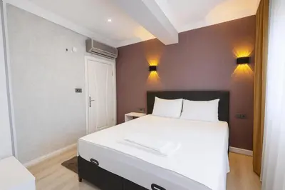 a bedroom with a large white bed with two pillows at Casa Florya Suites in Istanbul