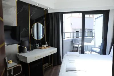 a bedroom with a white bed and a mirror at Madrigal Boutıque Hotel in Istanbul