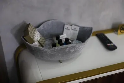 a bowl on top of a desk with a remote control at Madrigal Boutıque Hotel in Istanbul