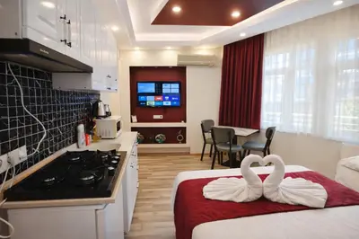 two swans sitting on a bed in a kitchen at Valentina Apart Hotel in Istanbul