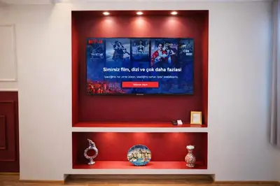 a wall with a television on a wall with vases on a shelf at Valentina Apart Hotel in Istanbul