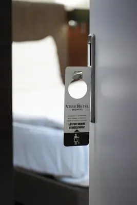 a door with a tag on it with a bed at Visse Hotel in Mudanya