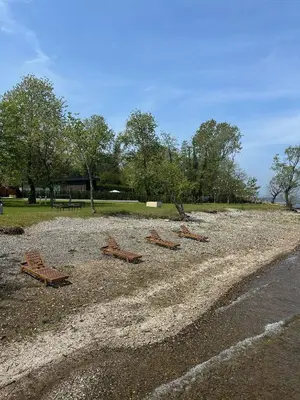 a group of wooden benches sitting on a beach at Kalimeras Deluxe Hotel in Sapanca
