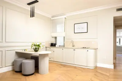 a white kitchen with a table and a sink at Vucino Suites in Istanbul