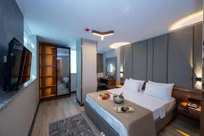a bedroom with a large bed and a bathroom at Vess Hotel in Istanbul