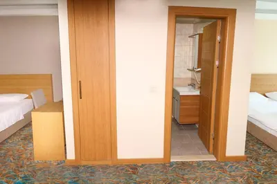 a hotel room with two beds and a bathroom at Helenapolis Otel in Yalova
