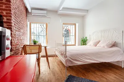 a bedroom with a bed and a brick wall at Armel Homes Taksim in Istanbul