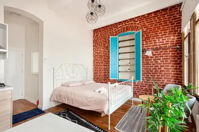 a bedroom with a bed and a brick wall at Armel Homes Taksim in Istanbul
