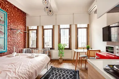 a room with a bed and a brick wall at Armel Homes Taksim in Istanbul
