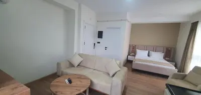 a living room with a couch and a table at Petra Port Hotel in Tuzla