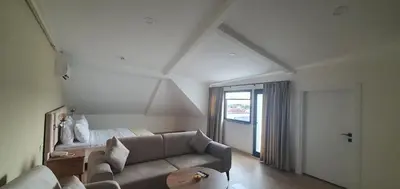 a living room with a couch and a table at Petra Port Hotel in Tuzla