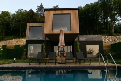 a house with a swimming pool and an umbrella at PANA Sapanca Lake View in Sapanca