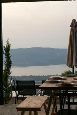 a table and chairs on a patio with a view at PANA Sapanca Lake View in Sapanca