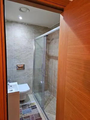 a bathroom with a shower and a toilet at Taksim Perfect Residence, 3 bedrooms, pool, sauna, gym in Istanbul