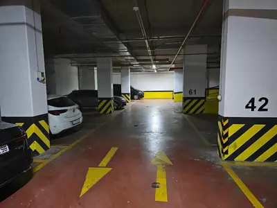 a large parking garage with cars parked in it at Taksim Perfect Residence, 3 bedrooms, pool, sauna, gym in Istanbul