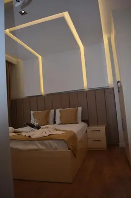 a bedroom with a bed with a large window above it at Garden Elisa Hotel in Istanbul