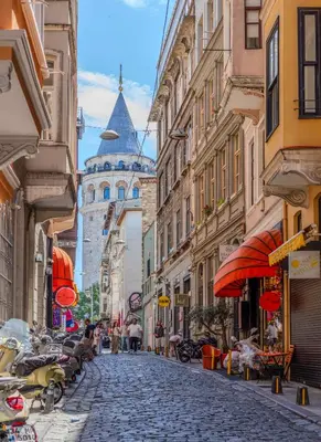 a cobblestone street in a city with buildings at Historic Spacious Galata Apartment in Istanbul