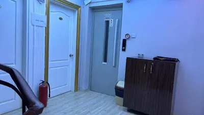 a hallway with a white door and a wooden floor at Falay Hotel Yavuz in Istanbul