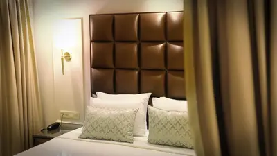 a bedroom with a bed with a brown headboard and pillows at Gaia Suites Istanbul in Istanbul