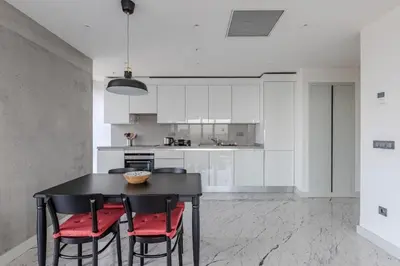 a kitchen with a black table and red chairs at Beautiful Elegant 1BD Private Terrace Gem! #333 in Istanbul